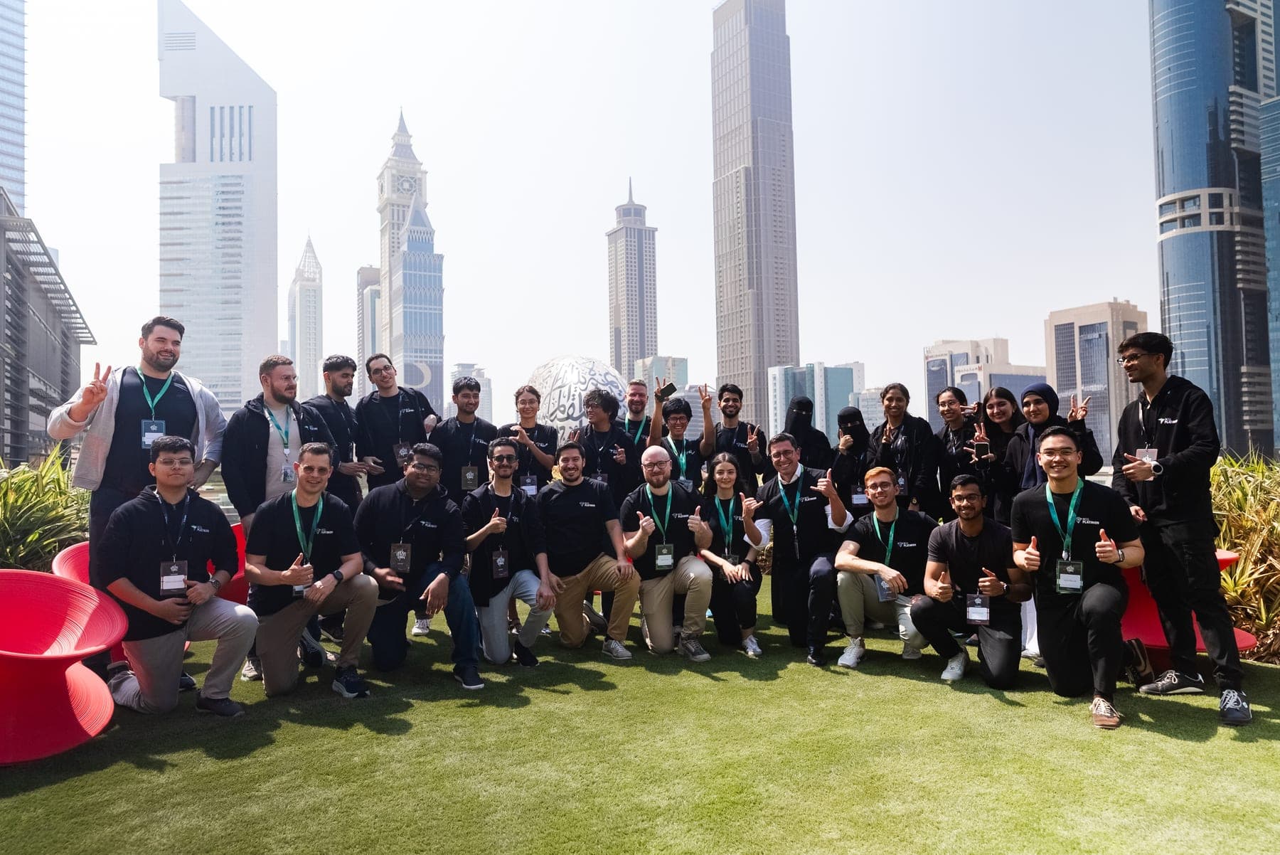 The full cohort on the rooftop, Dubai skyline behind us
