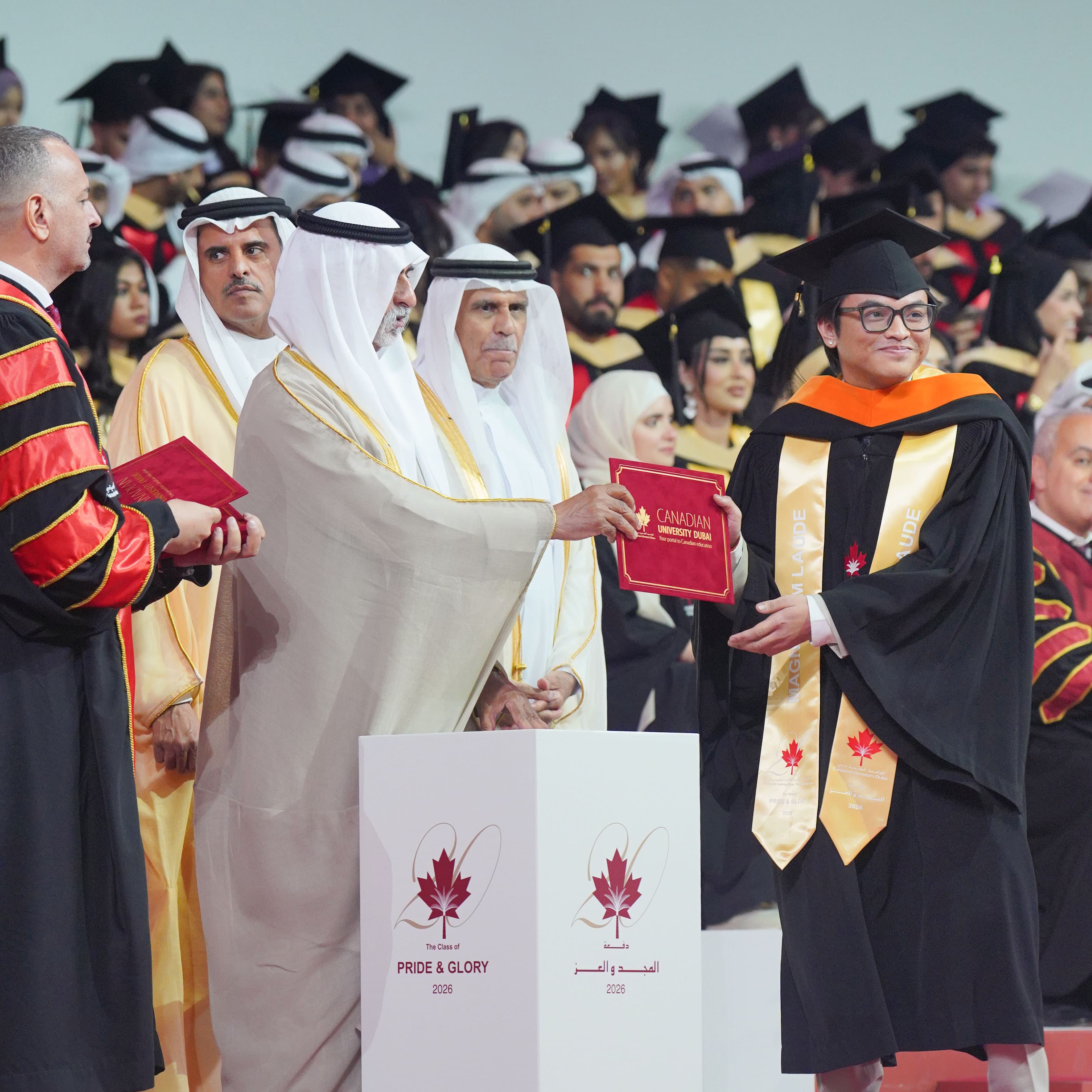 On stage, receiving my diploma in front of Canadian University Dubai's guests of honor, wearing the Magna Cum Laude stole